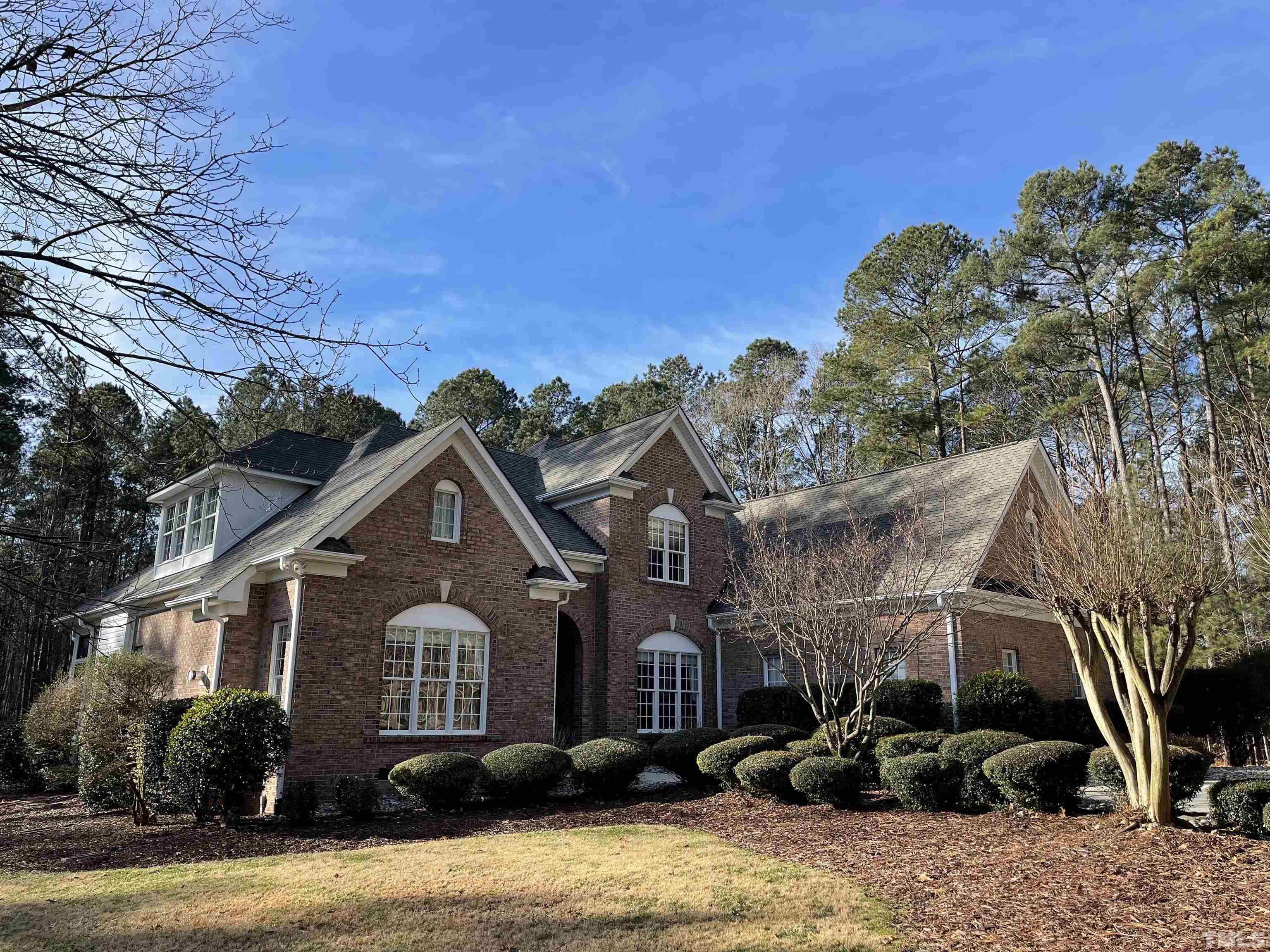3249 Grand Oak Lane New Hill, NC 27562 - Photo 2 of 65 a front view of a house with a yard
