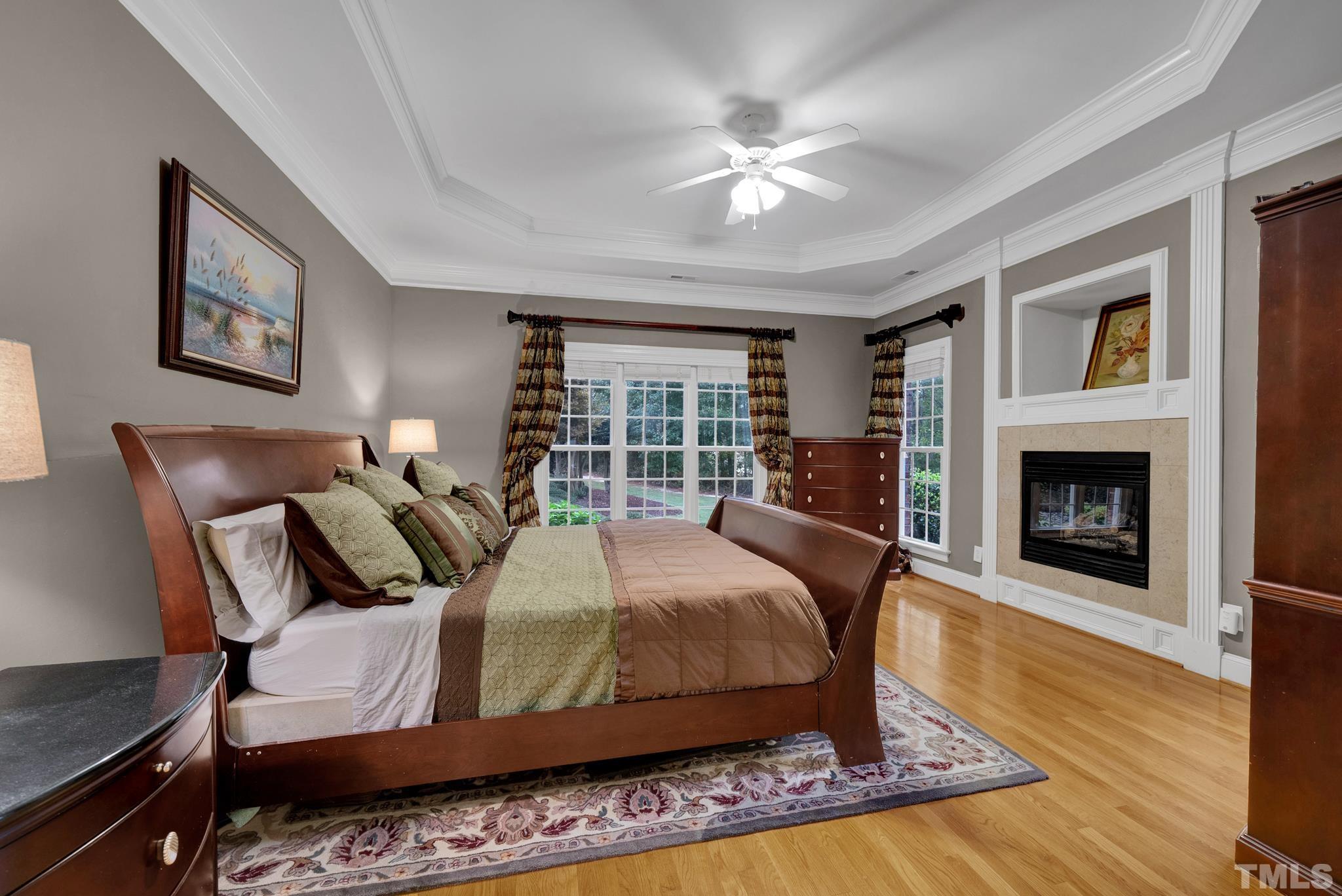 3249 Grand Oak Lane New Hill, NC 27562 - Photo 22 of 65 a bedroom with a bed and a fireplace