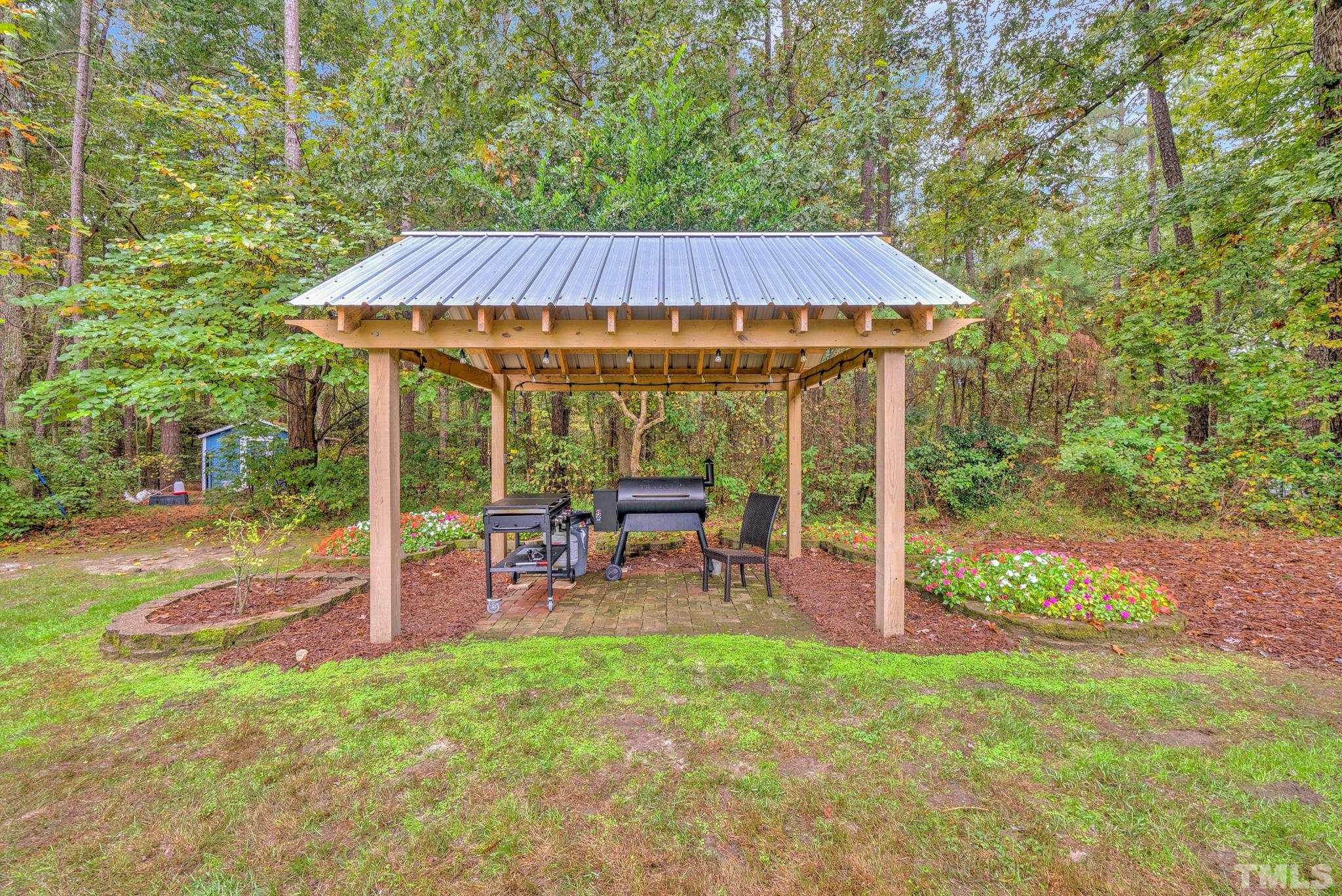 3249 Grand Oak Lane New Hill, NC 27562 - Photo 38 of 65 a view of a house with backyard and porch