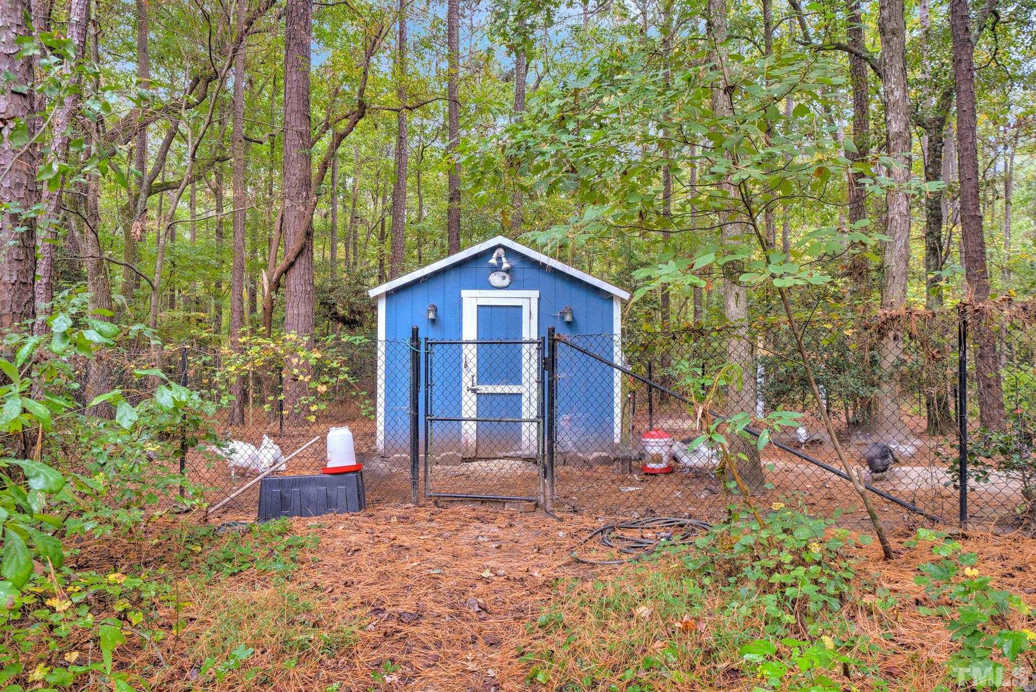 3249 Grand Oak Lane New Hill, NC 27562 - Photo 39 of 65 a view of a wooden house with a yard and large trees