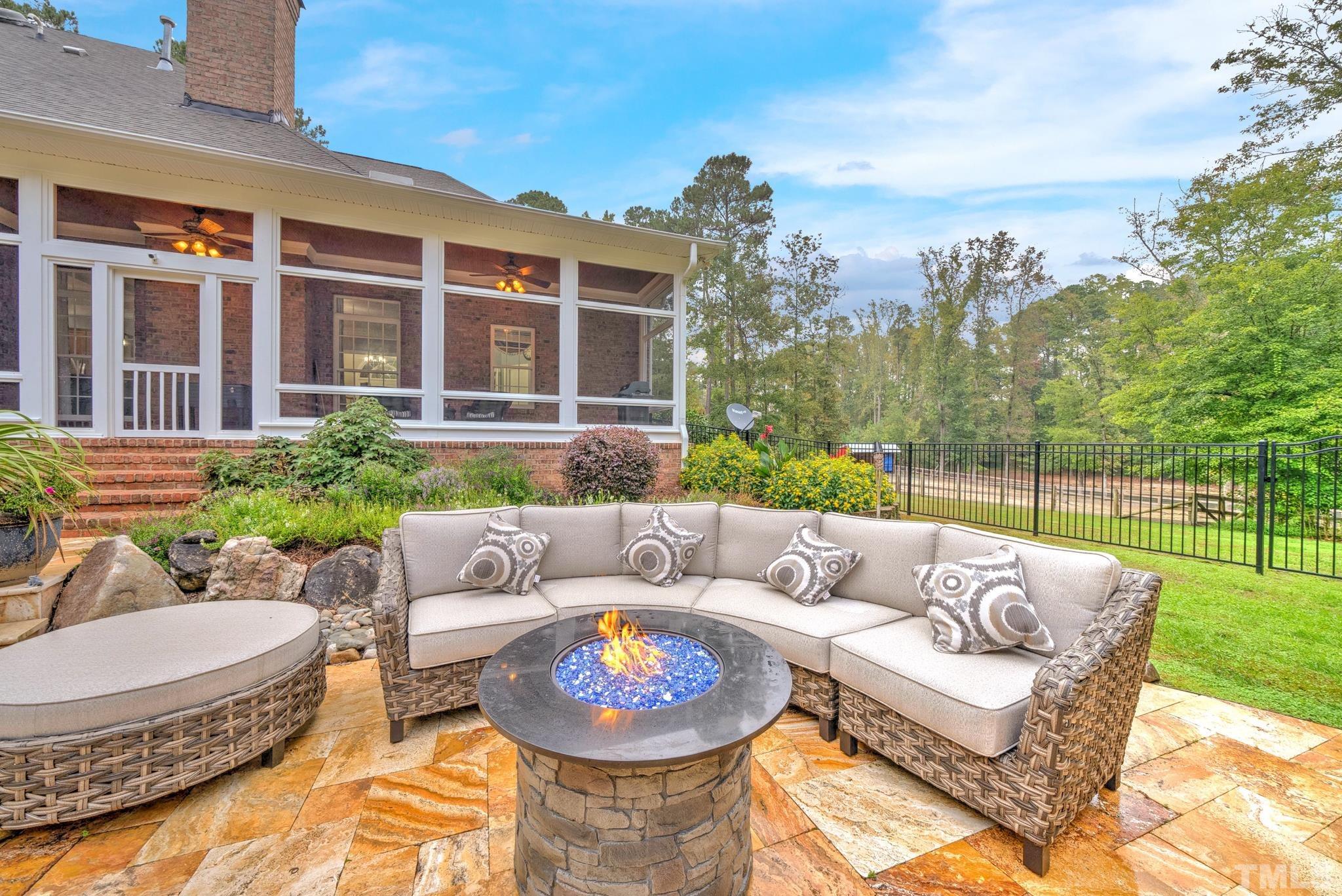 3249 Grand Oak Lane New Hill, NC 27562 - Photo 45 of 65 a view of a patio with couches chairs and a fire pit