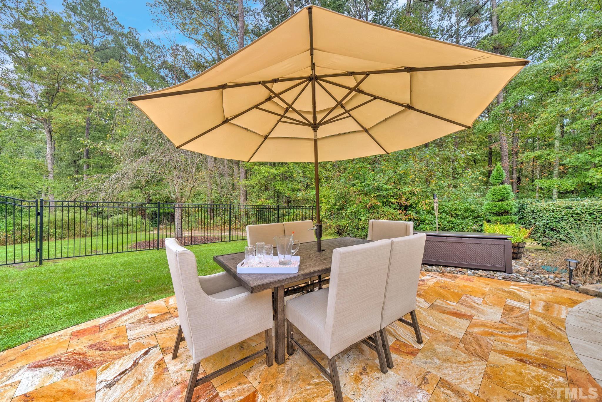 3249 Grand Oak Lane New Hill, NC 27562 - Photo 46 of 65 a patio with a yard table and chairs