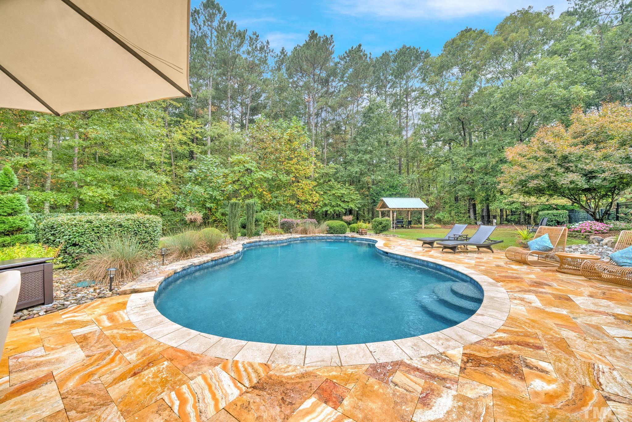 3249 Grand Oak Lane New Hill, NC 27562 - Photo 48 of 65 a view of a swimming pool with a yard