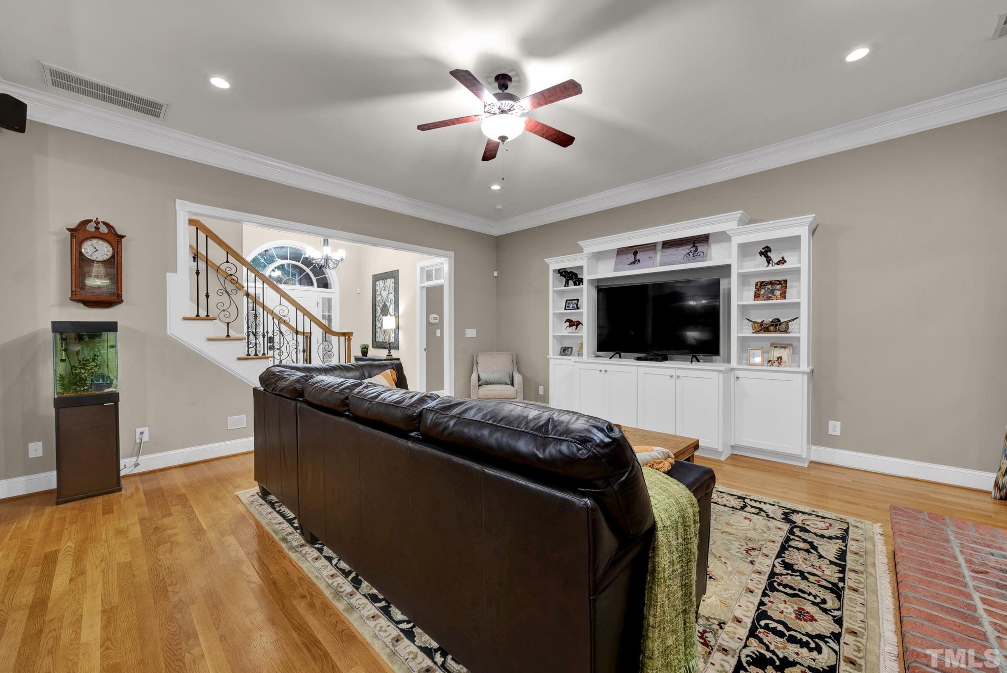 3249 Grand Oak Lane New Hill, NC 27562 - Photo 54 of 65 a living room with furniture and a flat screen tv