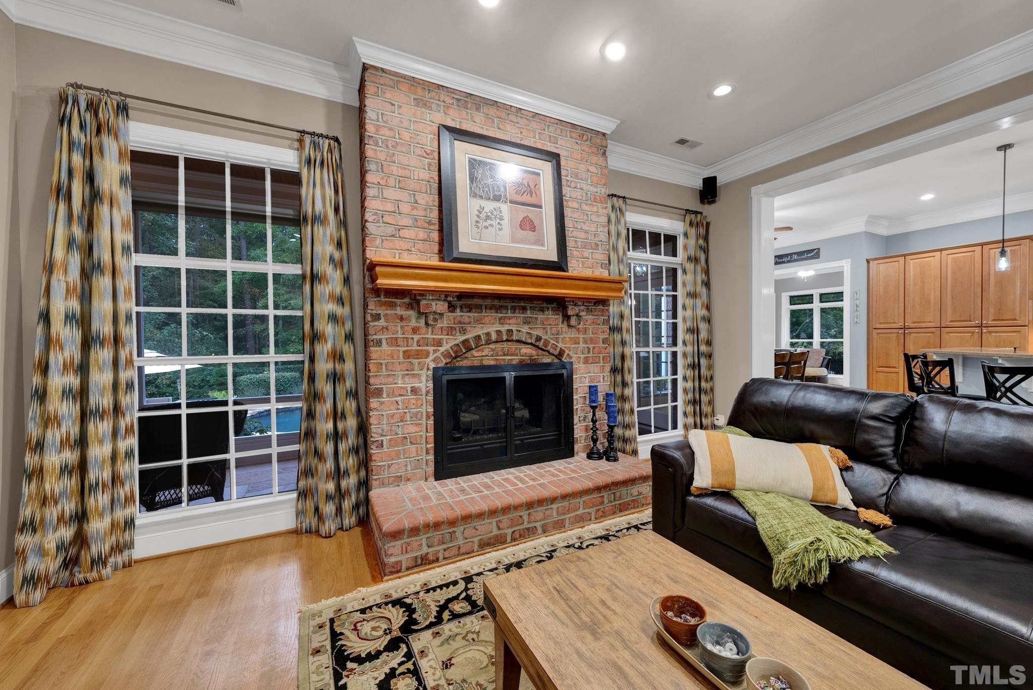 3249 Grand Oak Lane New Hill, NC 27562 - Photo 56 of 65 a living room with furniture and a fireplace
