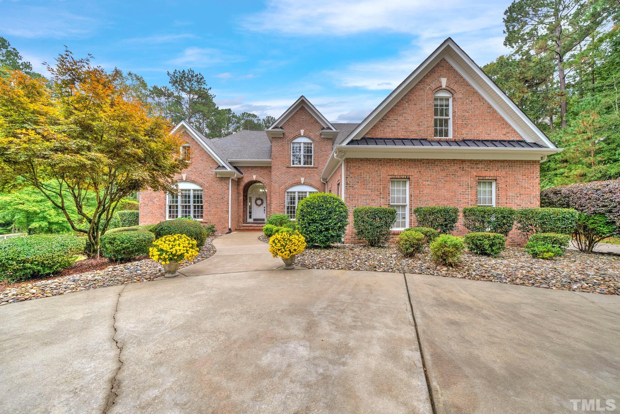 3249 Grand Oak Lane New Hill, NC 27562 - Photo 63 of 65 a front view of a house with a yard and a garage