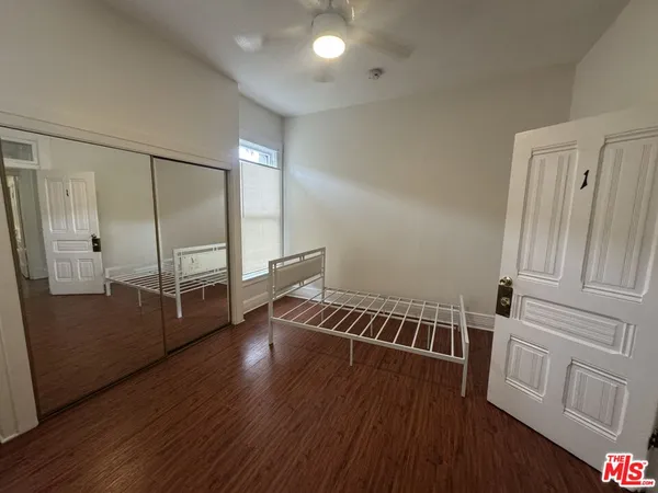 a view of a hallway with entryway wooden floor and front door