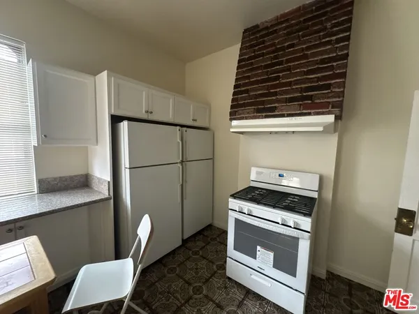 a kitchen with a stove and a refrigerator