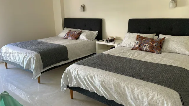 a view of a patio with chairs and potted plants