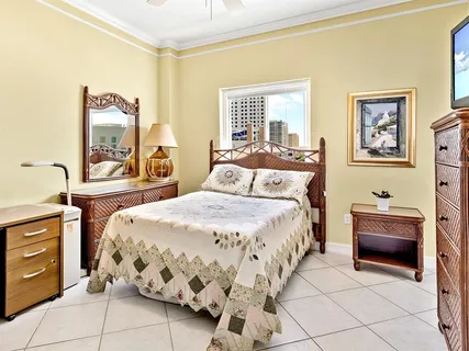 a bedroom with a bed and a dresser with mirror