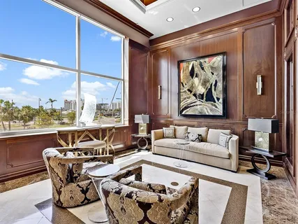 a living room with furniture and painting on the wall