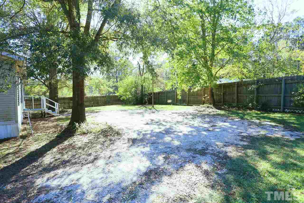 323 Aquilla Road, Unit A Benson, NC 27504 - Photo 2 of 25 a backyard of a house with lots of green space