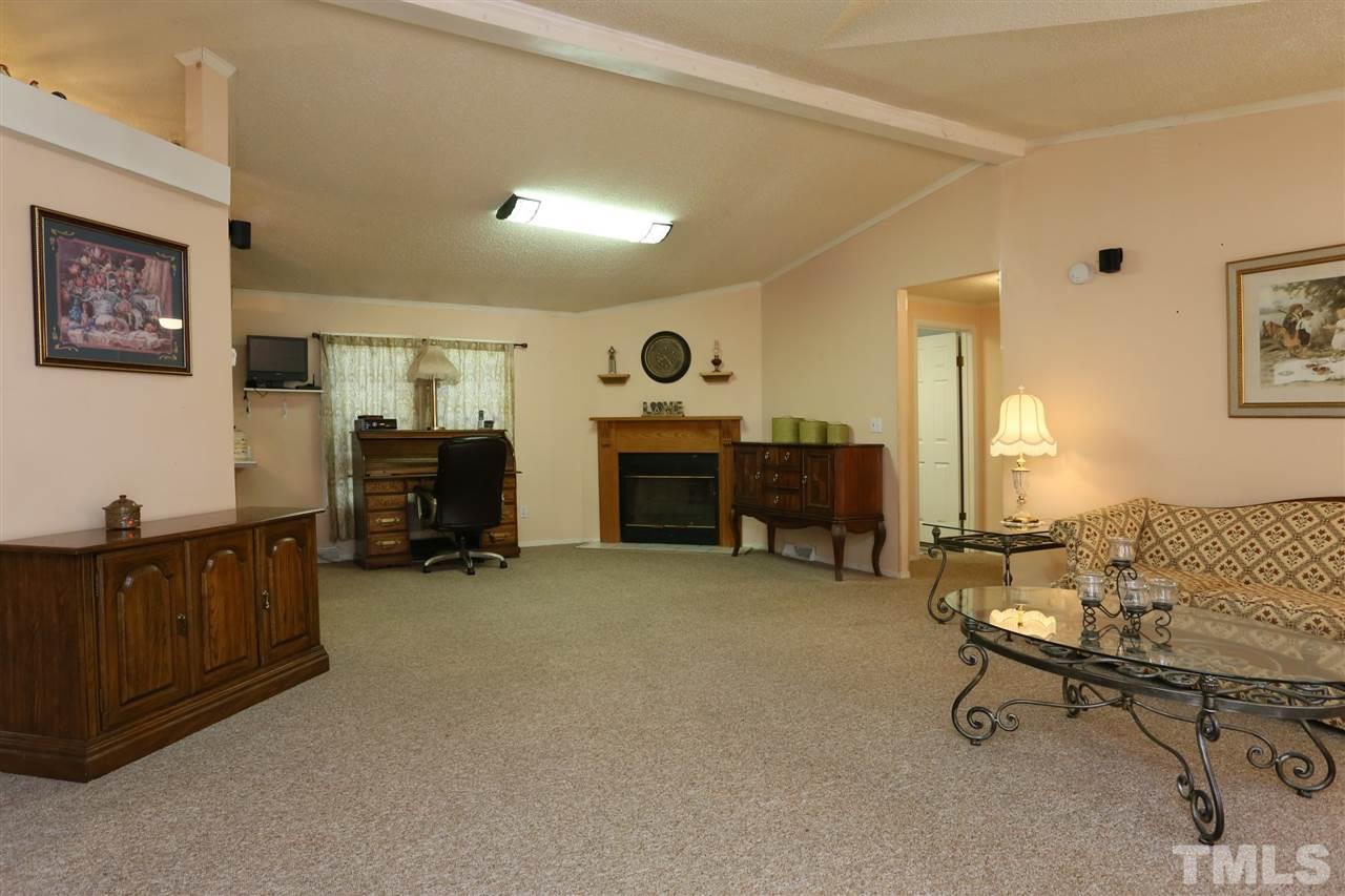 323 Aquilla Road, Unit A Benson, NC 27504 - Photo 12 of 25 a view of a livingroom with workspace and a window