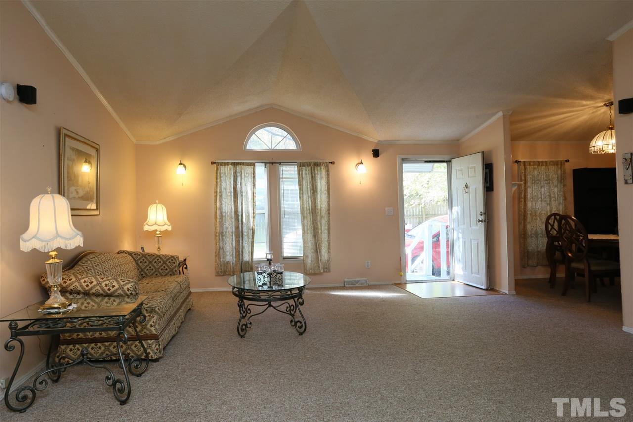 323 Aquilla Road, Unit A Benson, NC 27504 - Photo 14 of 25 a living room with furniture and a large window