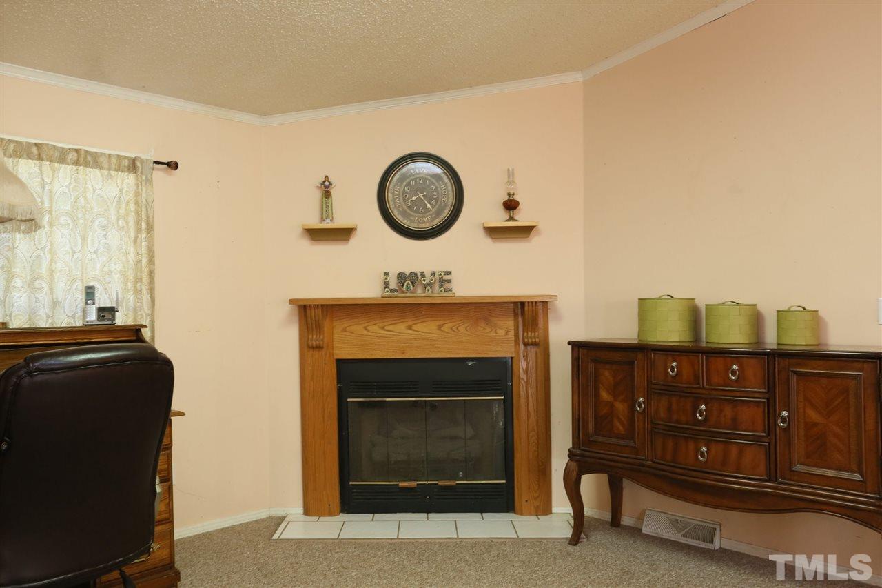 323 Aquilla Road, Unit A Benson, NC 27504 - Photo 15 of 25 a view of a livingroom with furniture and a fireplace