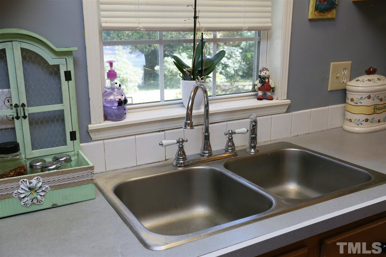 323 Aquilla Road, Unit A Benson, NC 27504 - Photo 20 of 25 a kitchen with a sink and a potted plant