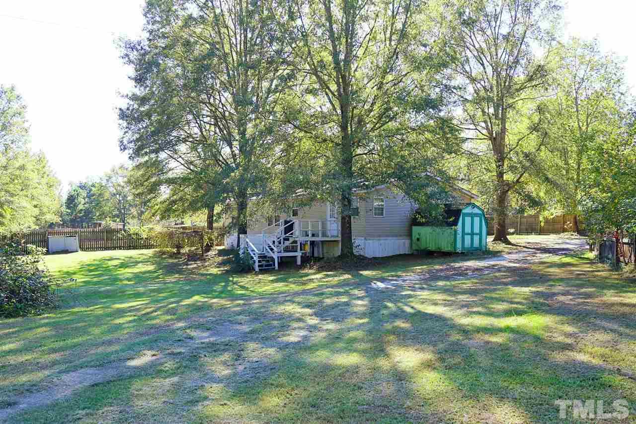 323 Aquilla Road, Unit A Benson, NC 27504 - Photo 3 of 25 a view of a house with backyard and trees