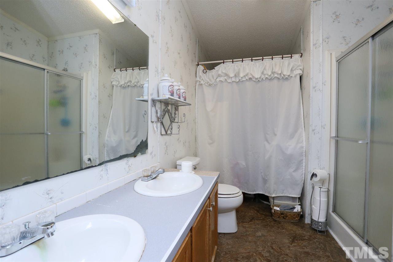 323 Aquilla Road, Unit A Benson, NC 27504 - Photo 23 of 25 a bathroom with a sink toilet and shower