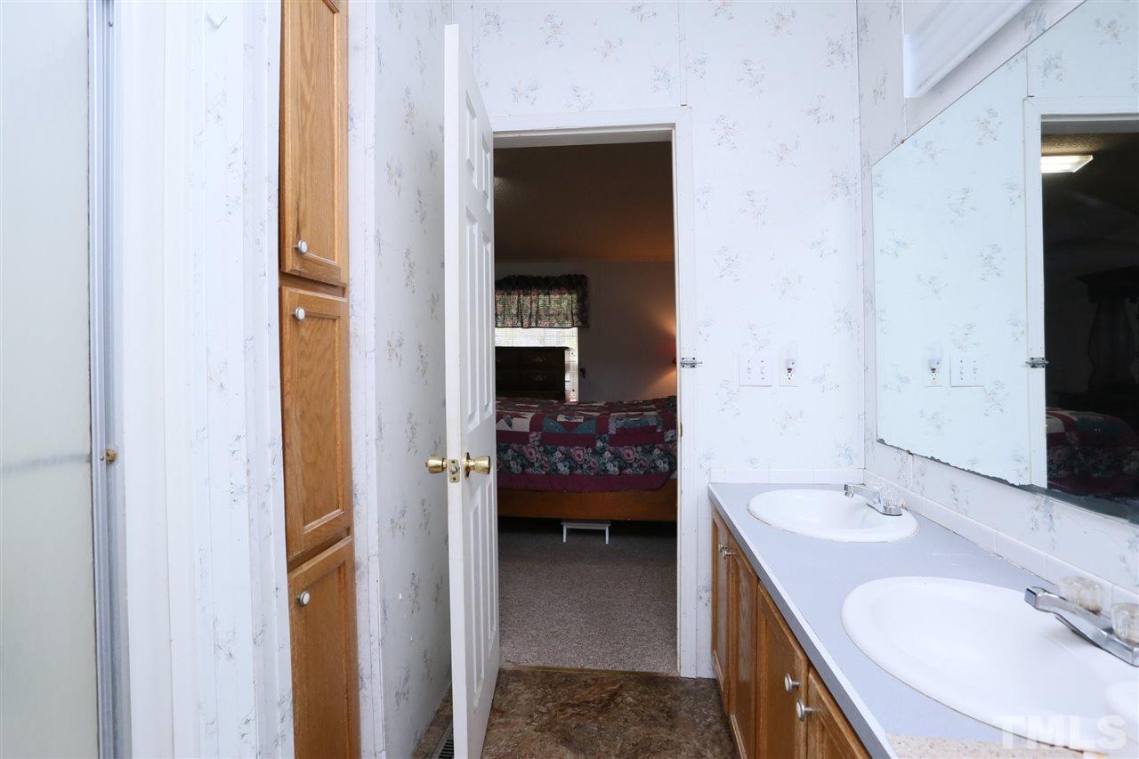 323 Aquilla Road, Unit A Benson, NC 27504 - Photo 24 of 25 a en suite bathroom with a sink and a mirror