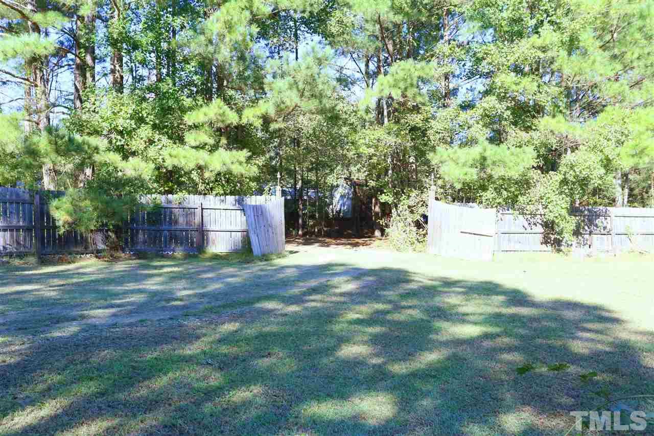 323 Aquilla Road, Unit A Benson, NC 27504 - Photo 9 of 25 a backyard of a house with a tree