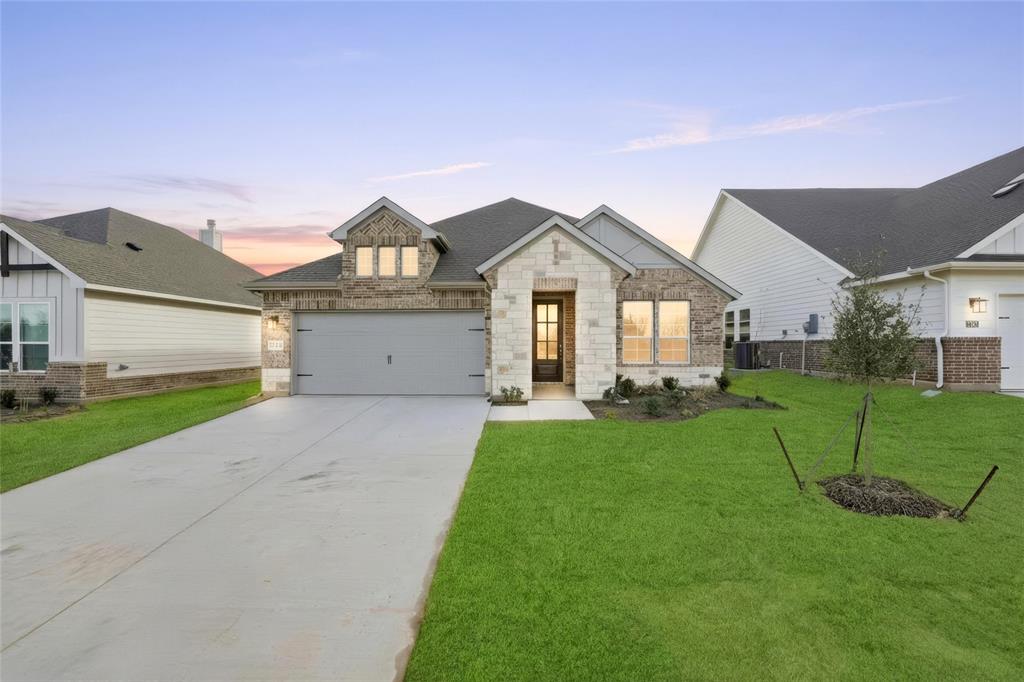 1244 Sabine River Lane Springtown, TX 76082 - Photo 1 of 26 a front view of a house with a yard and trees