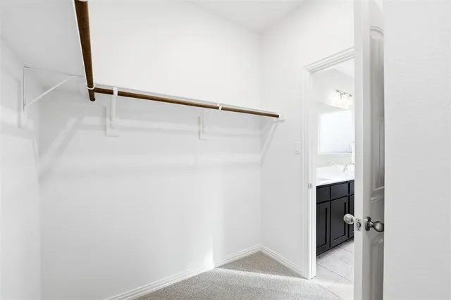 a view of walk in closet with clothes