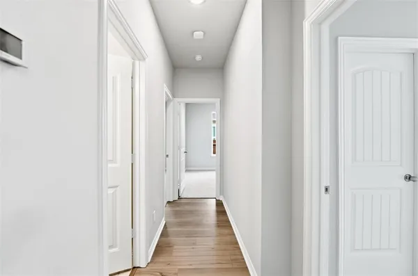 a view of a hallway with a wooden door