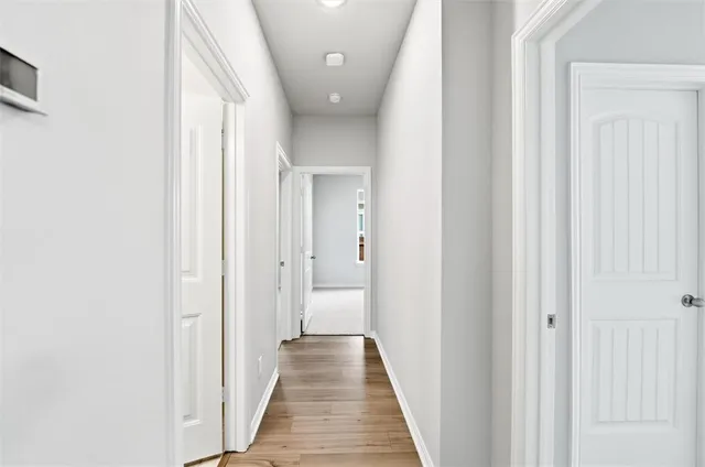 a view of a hallway with a wooden door