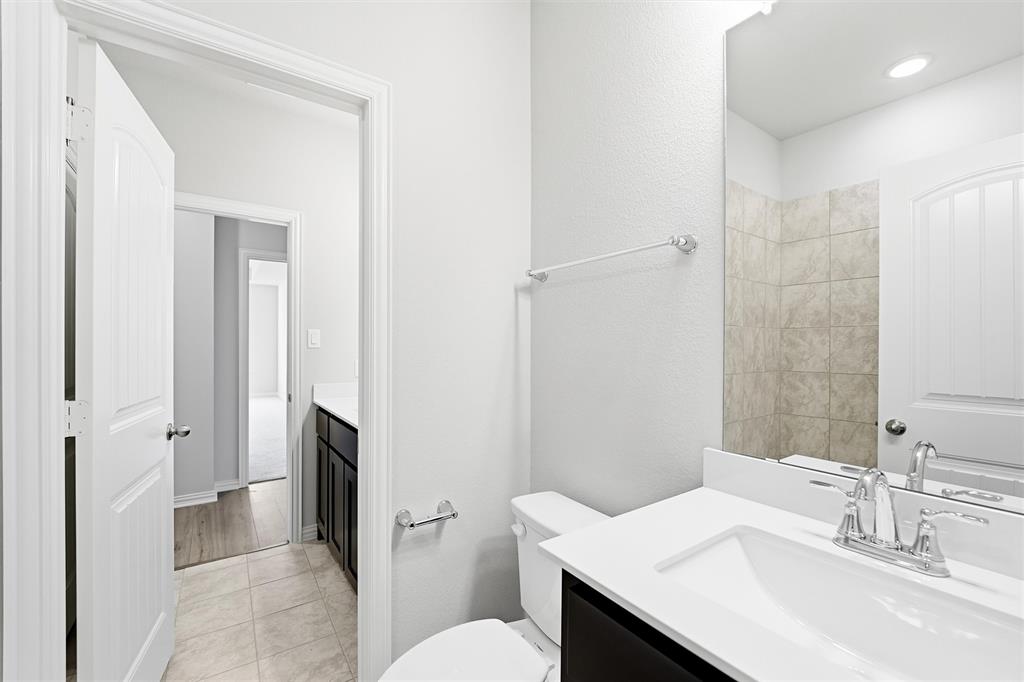 1244 Sabine River Lane Springtown, TX 76082 - Photo 19 of 26 a bathroom with a sink toilet and shower