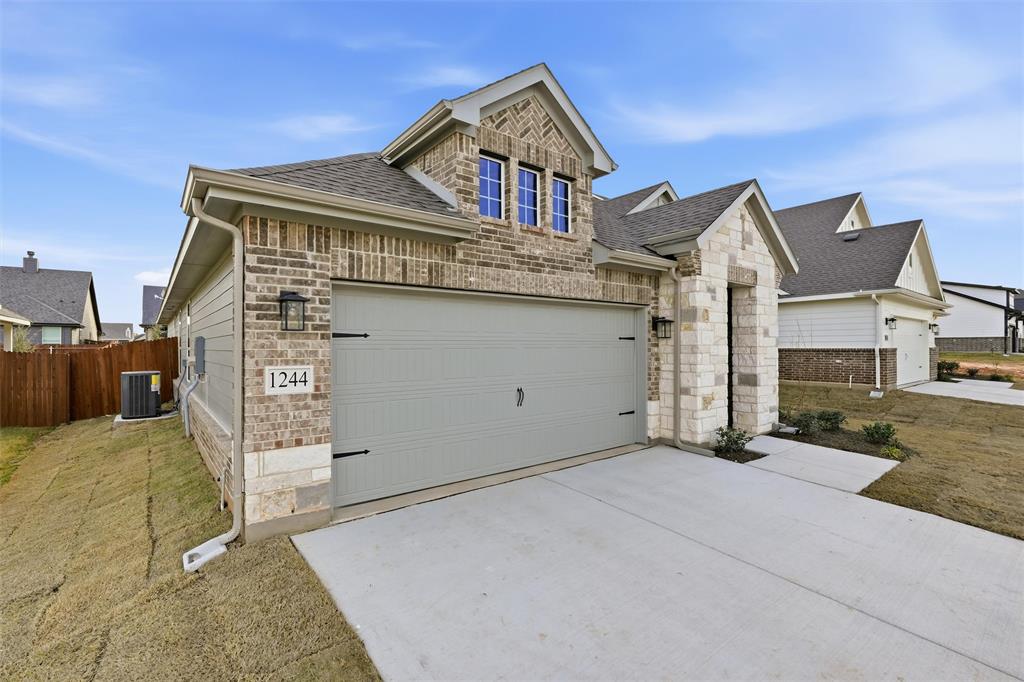 1244 Sabine River Lane Springtown, TX 76082 - Photo 4 of 26 a front view of a house with a garage
