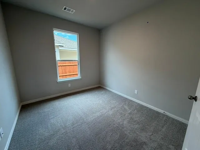 an empty room with a empty space and windows