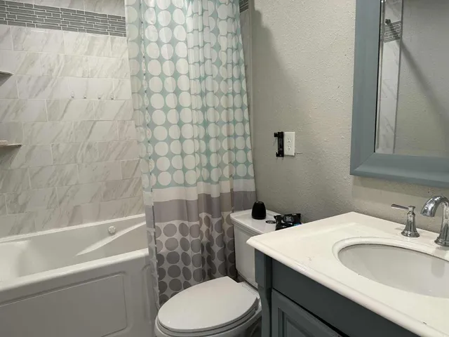 a bathroom with a sink a toilet and a bathtub