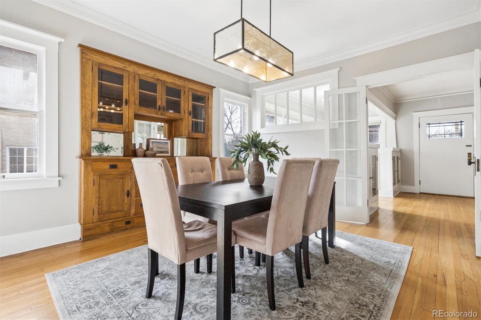 736 York Street Denver, CO 80206 - Photo 13 of 50 a view of a dining room with furniture and wooden floor