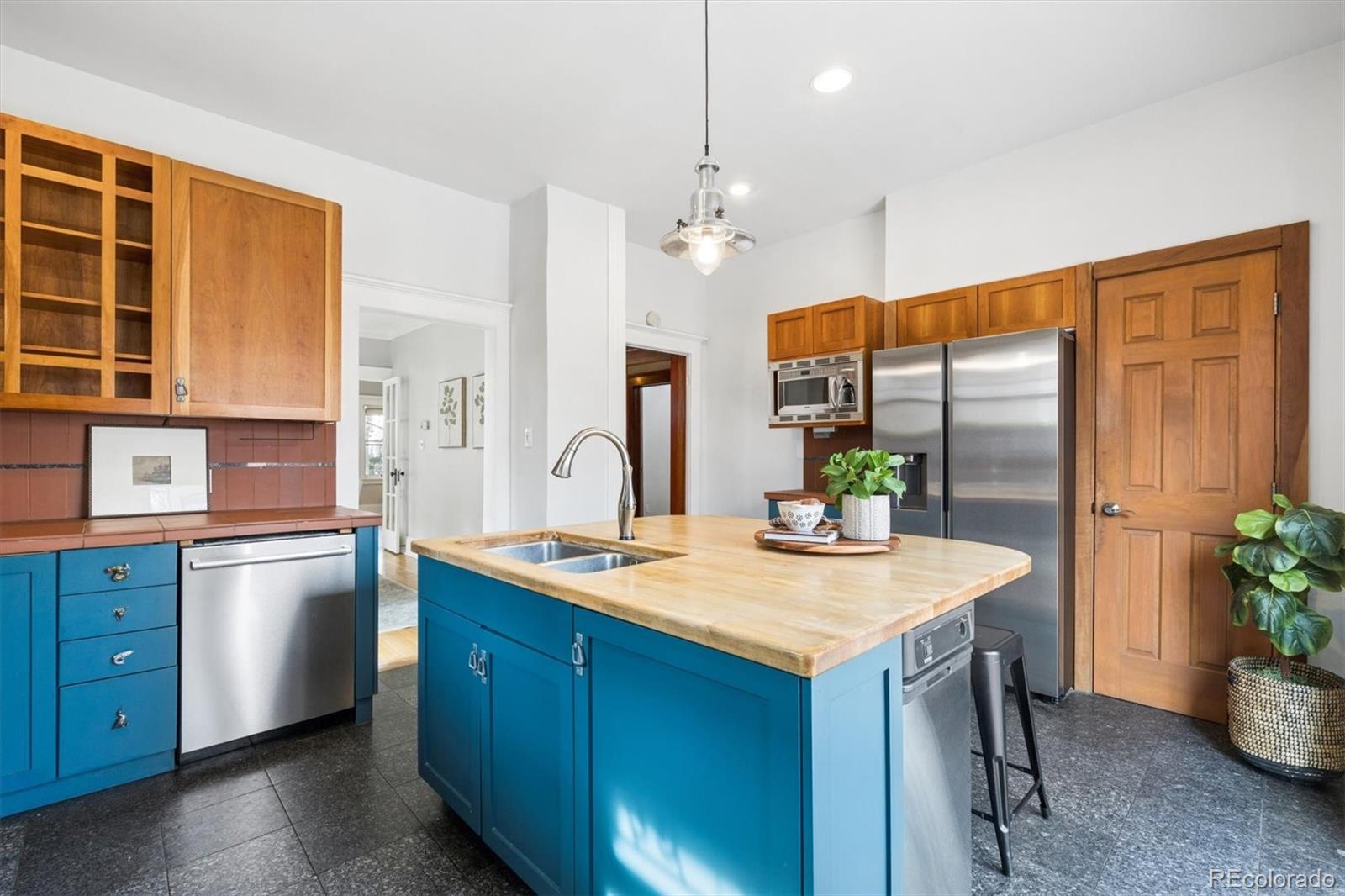 736 York Street Denver, CO 80206 - Photo 18 of 50 a kitchen with a refrigerator a sink and a stove
