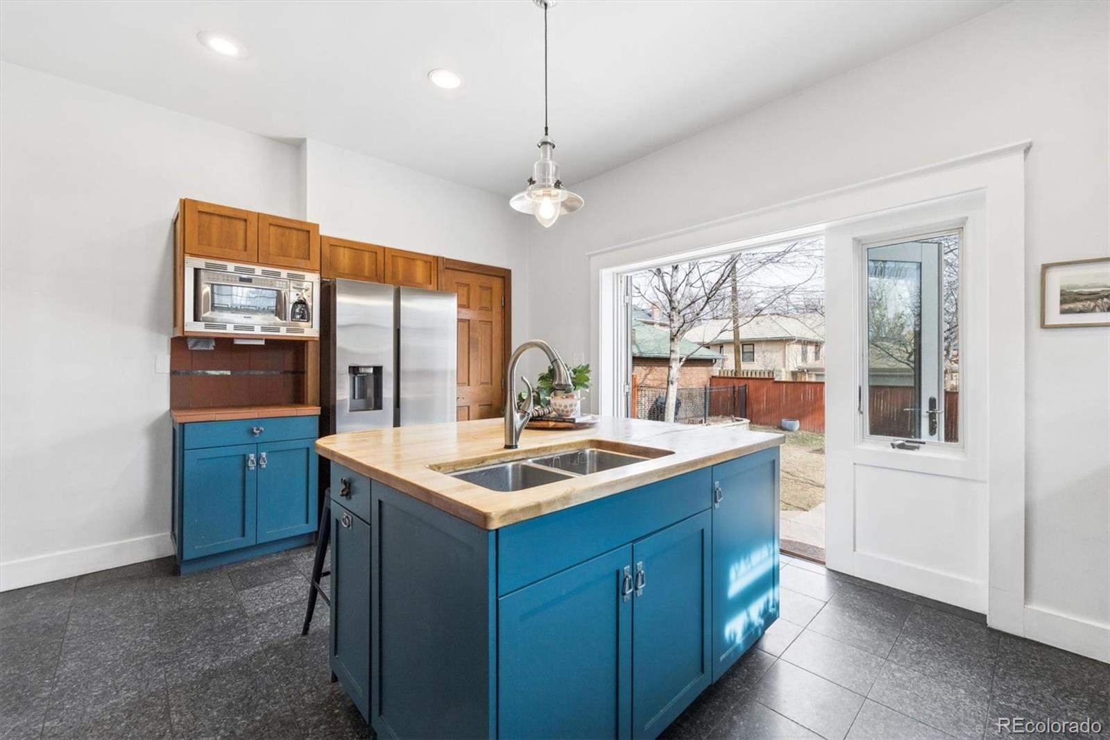 736 York Street Denver, CO 80206 - Photo 19 of 50 a kitchen with a sink and a refrigerator