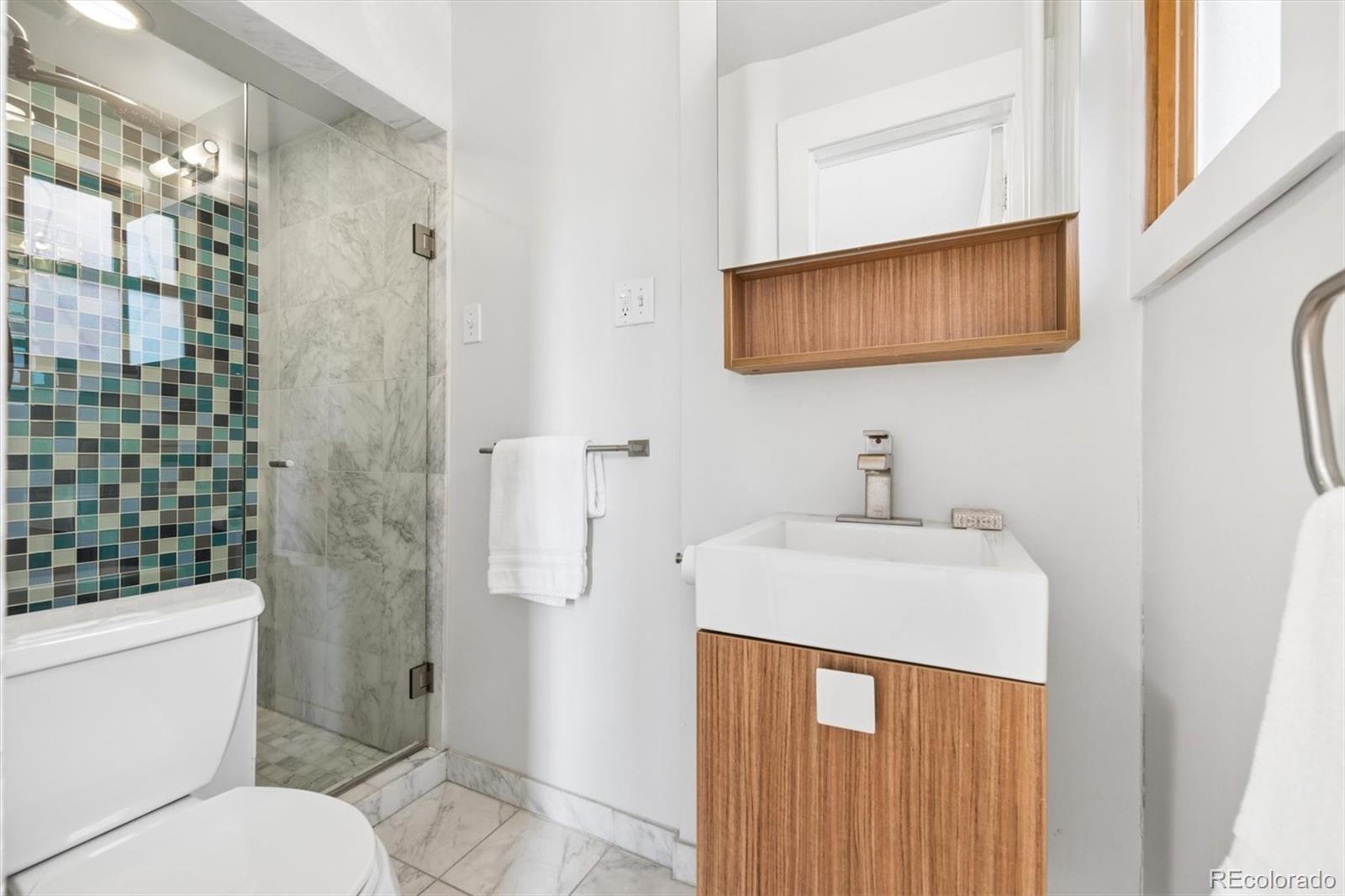 736 York Street Denver, CO 80206 - Photo 21 of 50 a bathroom with a sink a toilet and shower