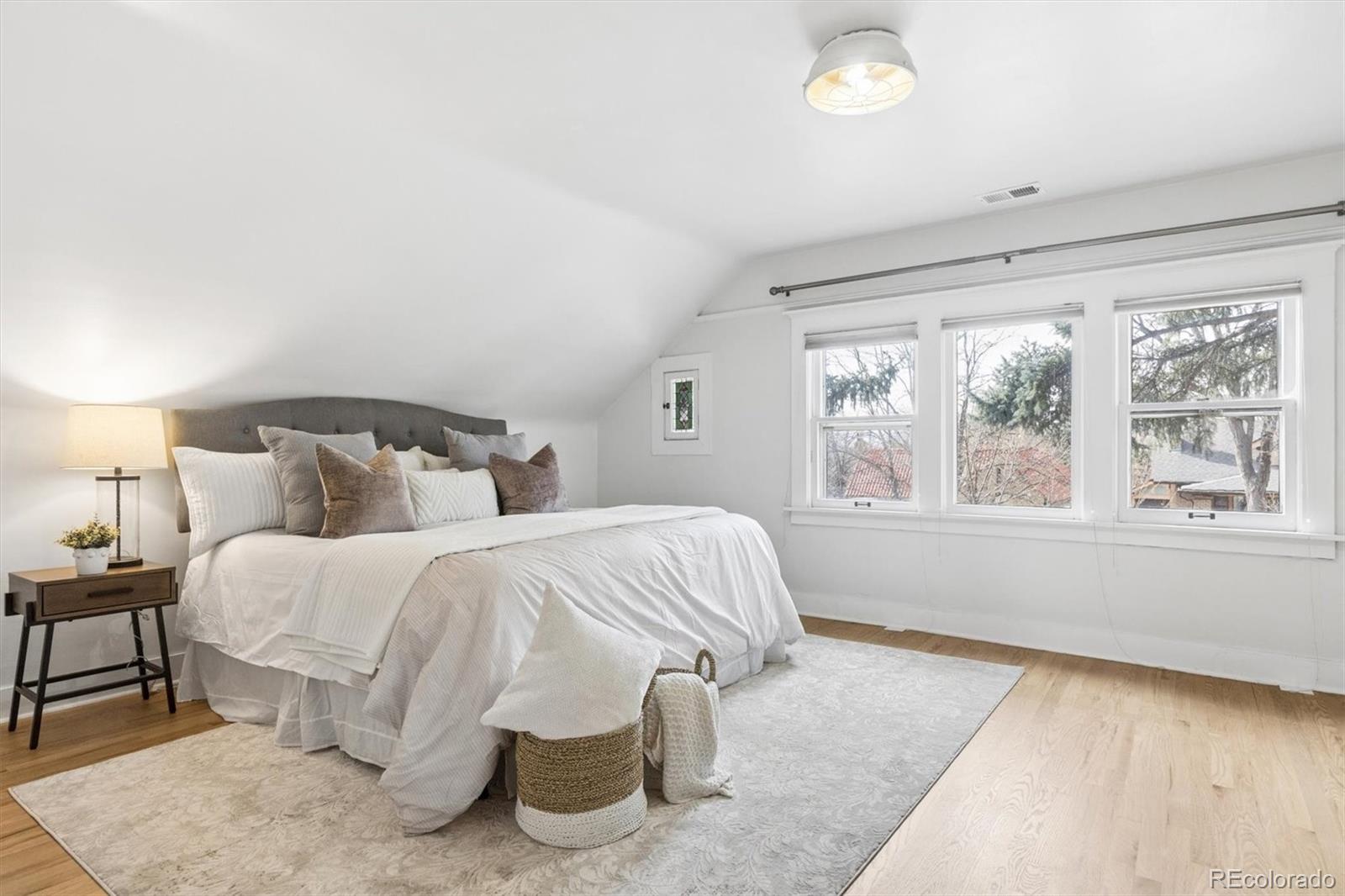 736 York Street Denver, CO 80206 - Photo 25 of 50 a spacious bedroom with two beds and a large window