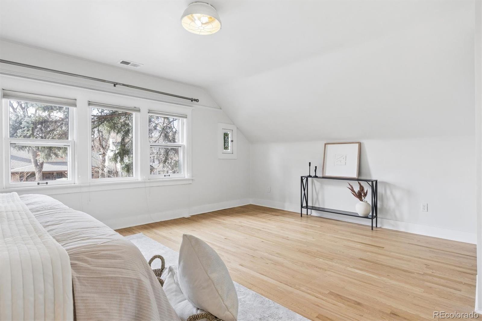 736 York Street Denver, CO 80206 - Photo 26 of 50 a bedroom with a bed and a window