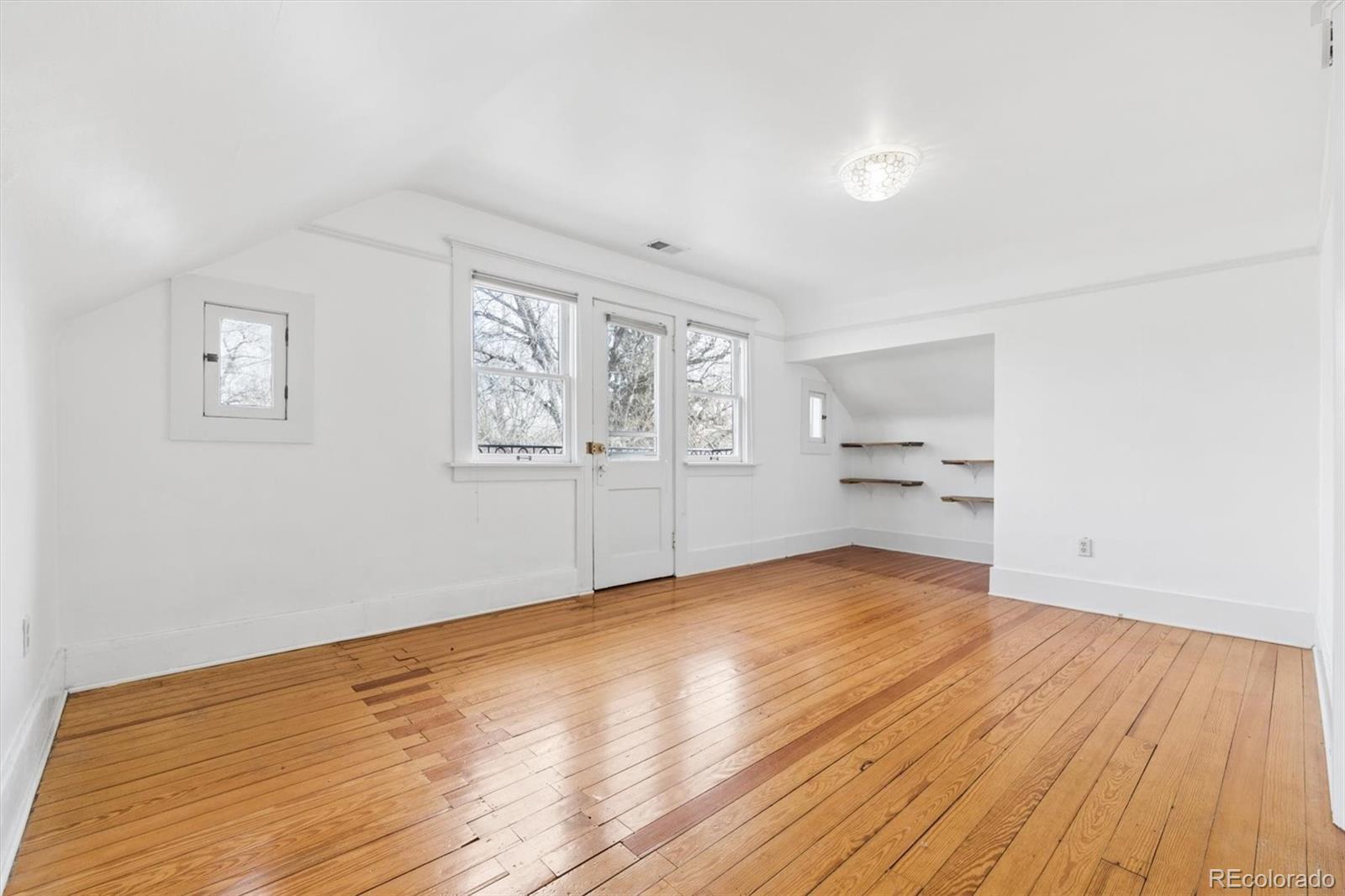 736 York Street Denver, CO 80206 - Photo 33 of 50 a view of empty room with wooden floor and fan