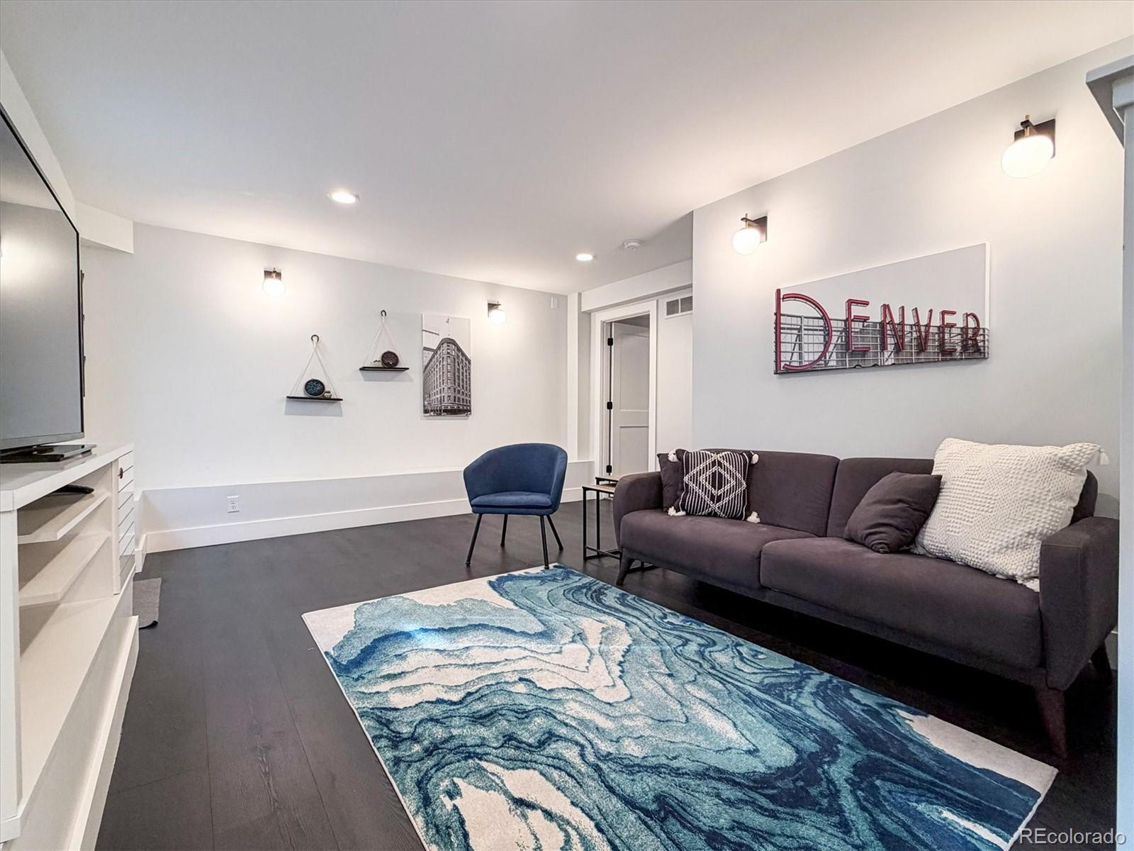 736 York Street Denver, CO 80206 - Photo 35 of 50 a living room with furniture and a rug