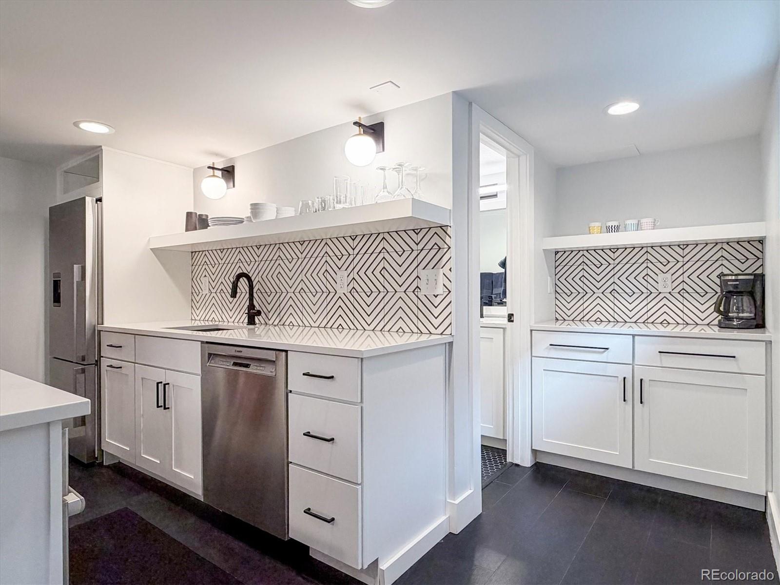 736 York Street Denver, CO 80206 - Photo 39 of 50 a kitchen with white cabinets and sink