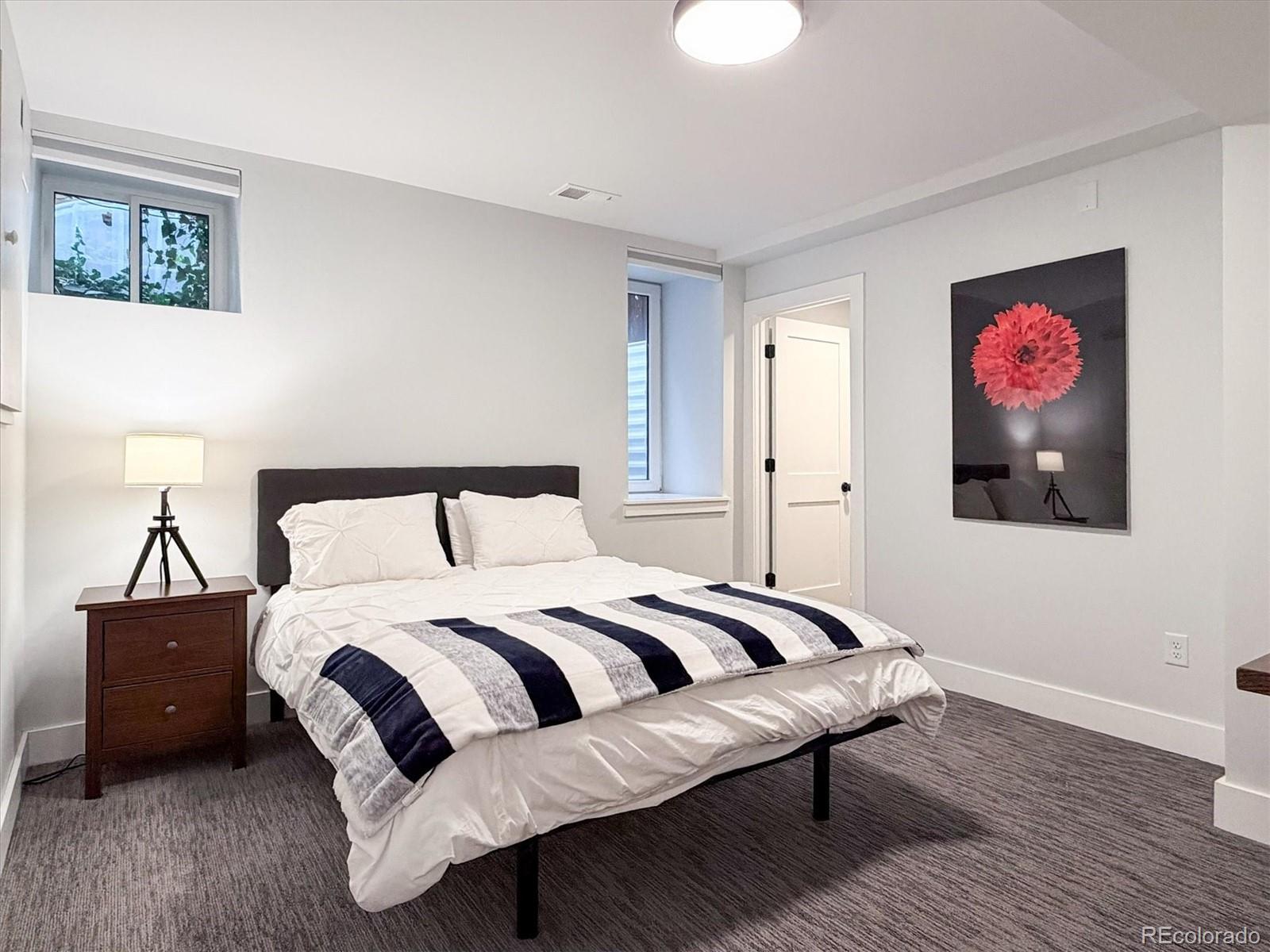 736 York Street Denver, CO 80206 - Photo 42 of 50 a bedroom with a bed and a wall painting