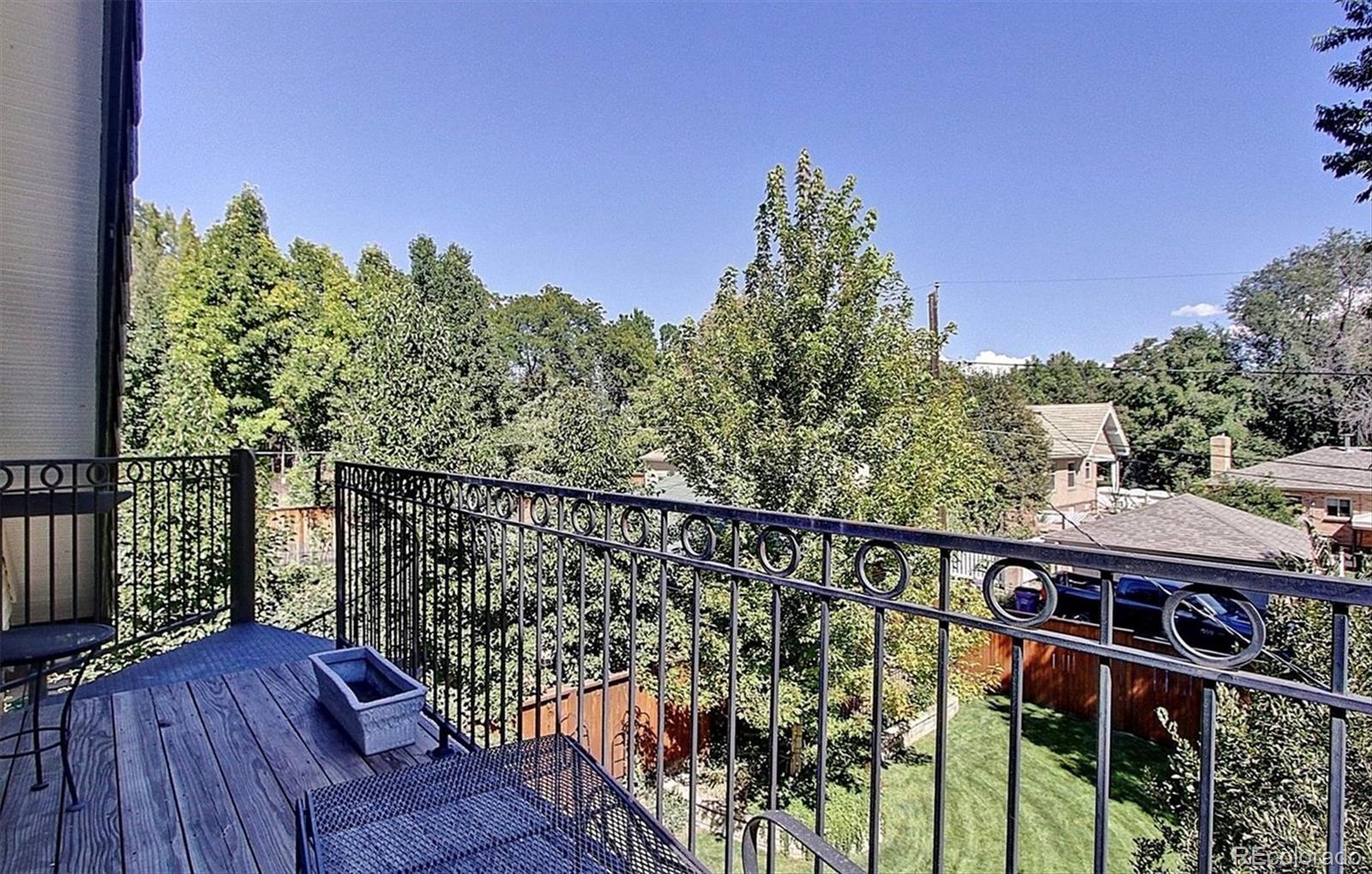 736 York Street Denver, CO 80206 - Photo 45 of 50 a balcony with wooden floor and fence