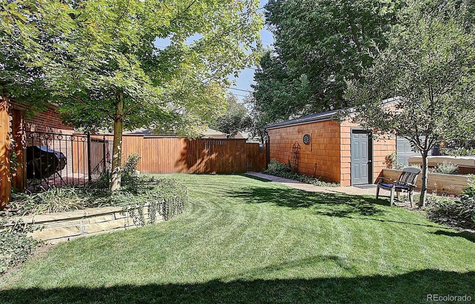736 York Street Denver, CO 80206 - Photo 49 of 50 a backyard of a house with a large tree and swing