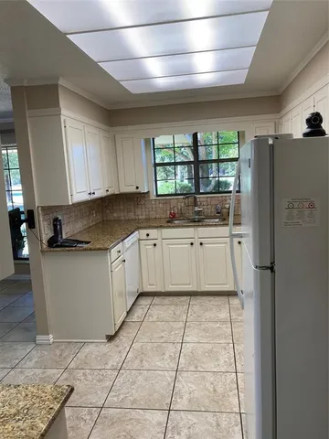 a large kitchen with a stove a sink dishwasher and a refrigerator