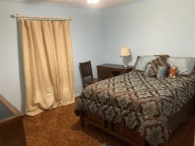 a bedroom with a bed and a mirror