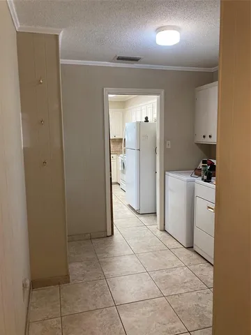 a view of a storage & utility room with closet dryer