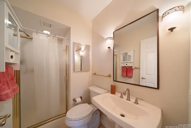 a bathroom with a sink toilet and shower