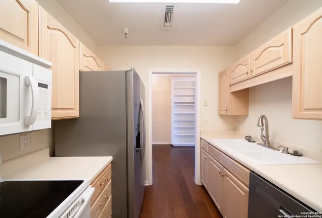 a kitchen with a sink and a refrigerator