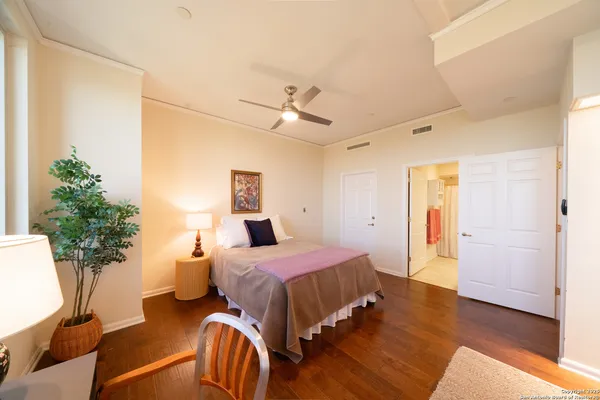 a bedroom with a bed and a potted plant